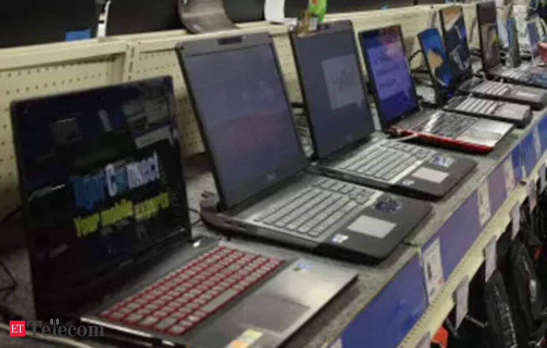 Various laptops on display in a store.