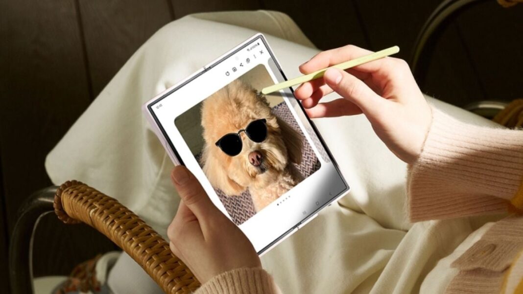 Person editing photo of dog wearing sunglasses on tablet.