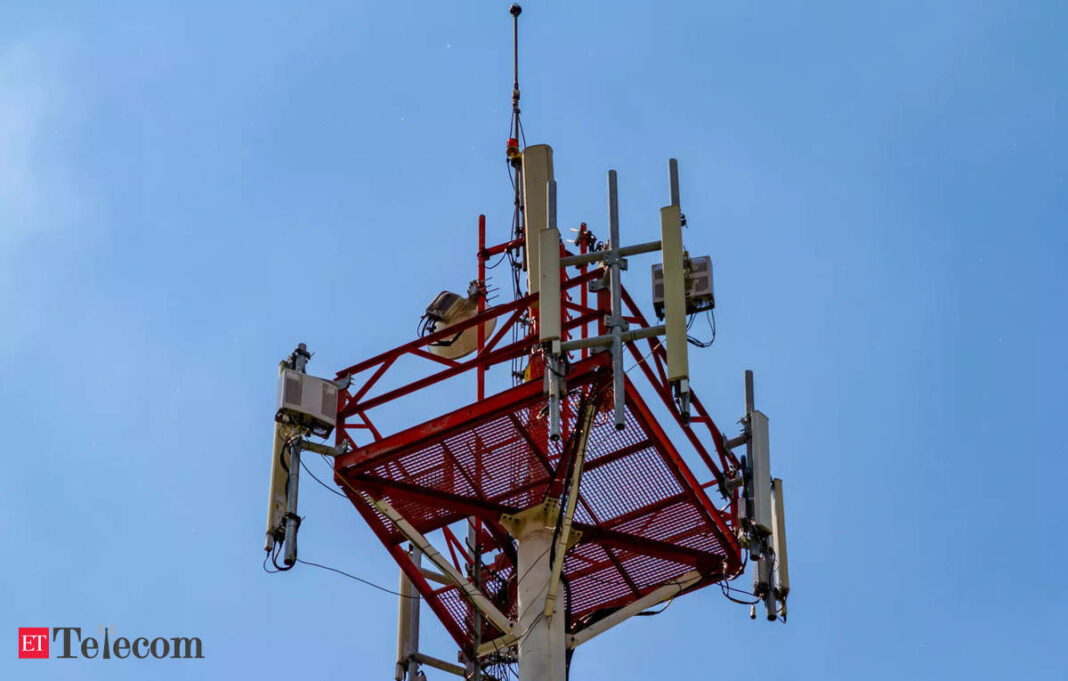 Cellular tower against blue sky.