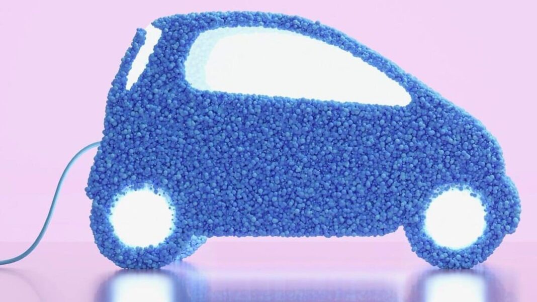 Blue car sculpture with plug, on pink background.