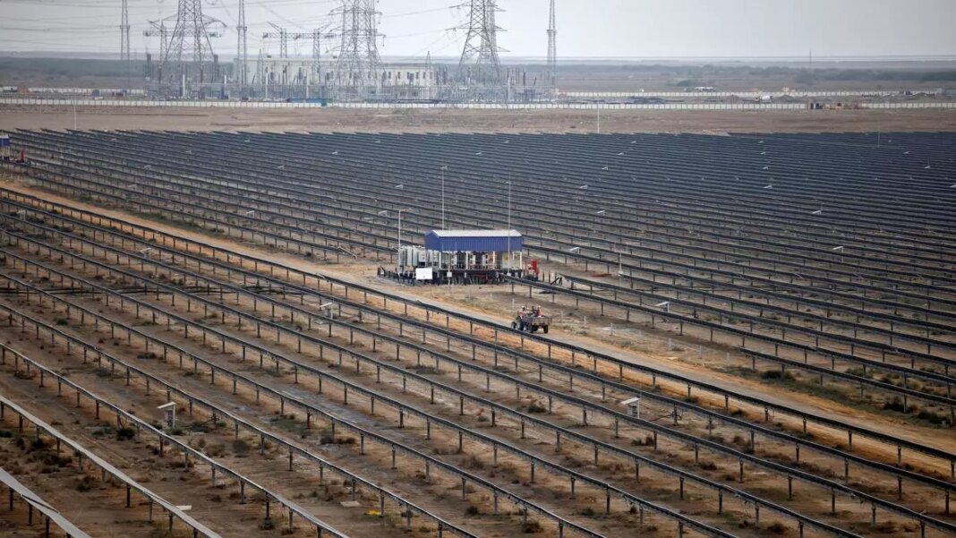 Vast solar panel field with maintenance hut.