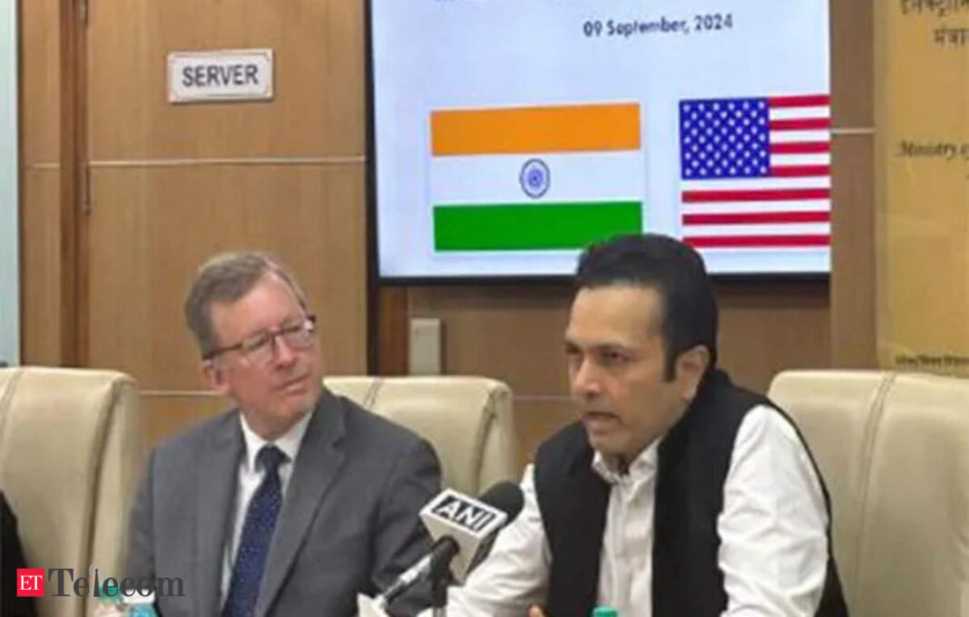 Indo-US meeting with officials, flags in background.