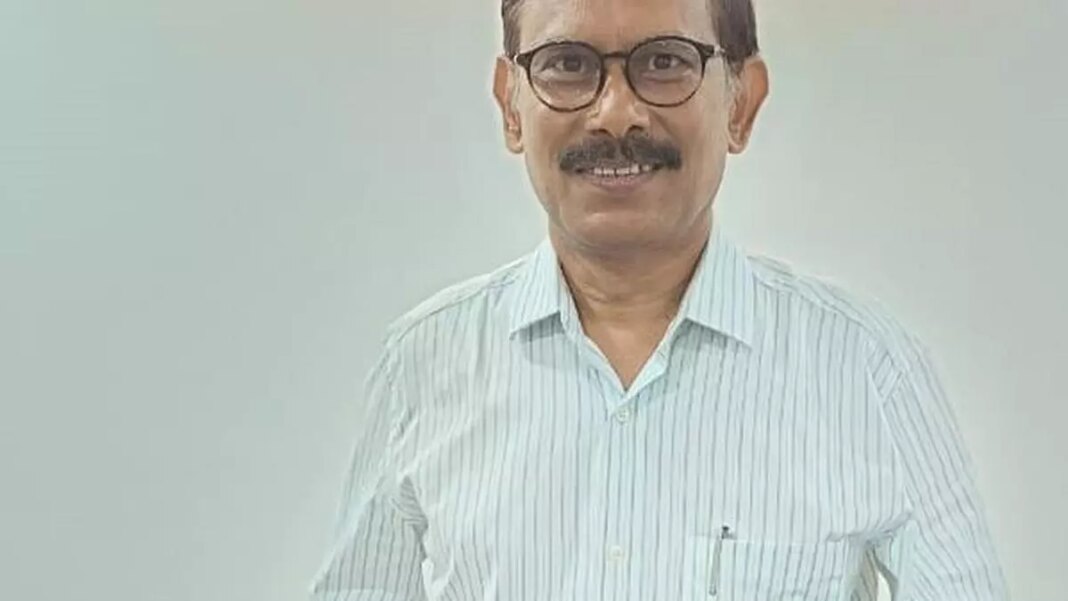 Smiling man with glasses wearing striped shirt.